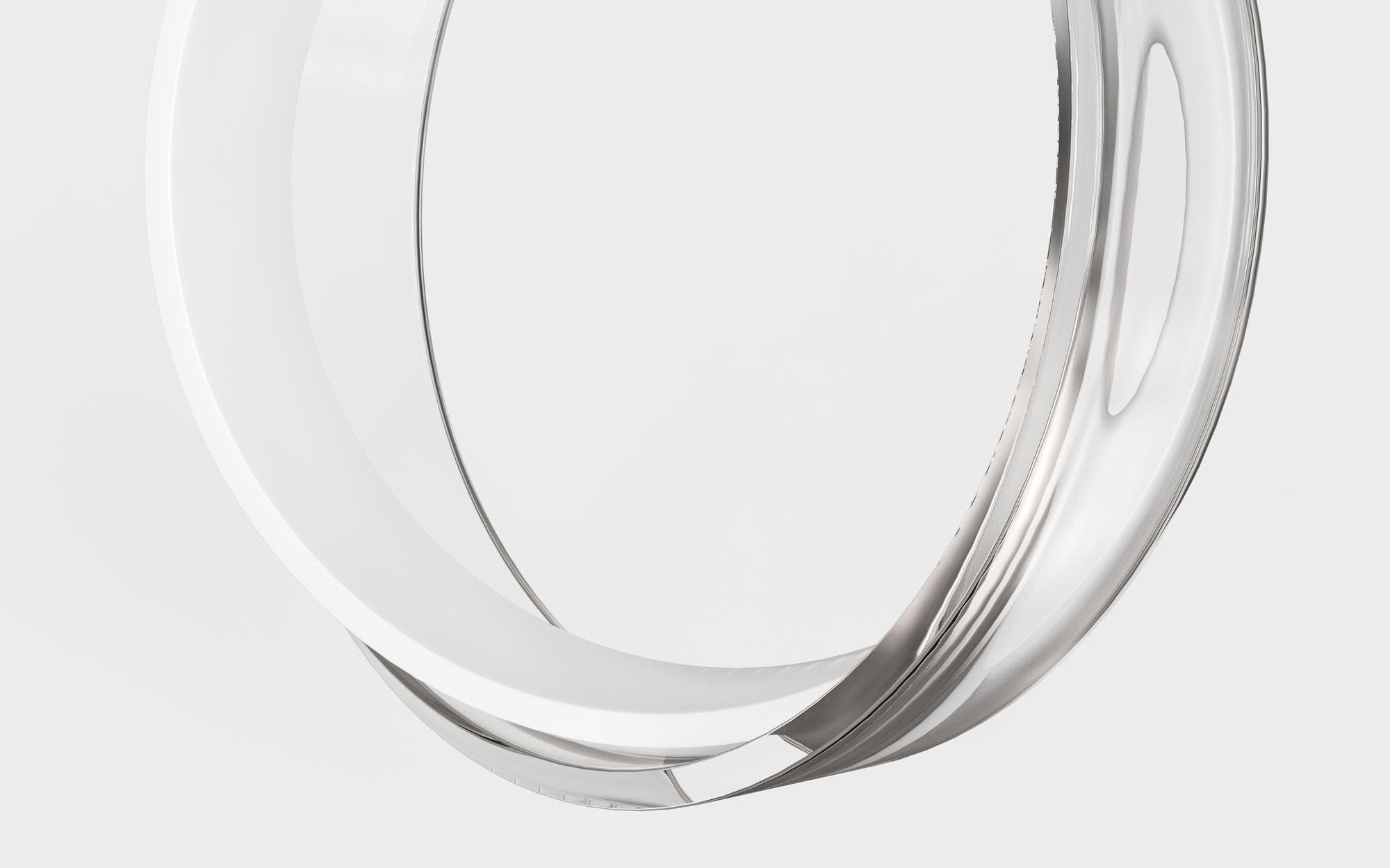 Polished chrome ring on a soft neutral surface